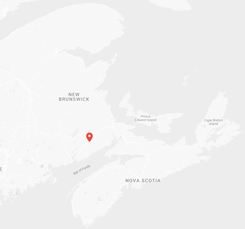 A light gray map of New Brunswick and Nova Scotia with a small red location pin marking a spot near the center of the image.
